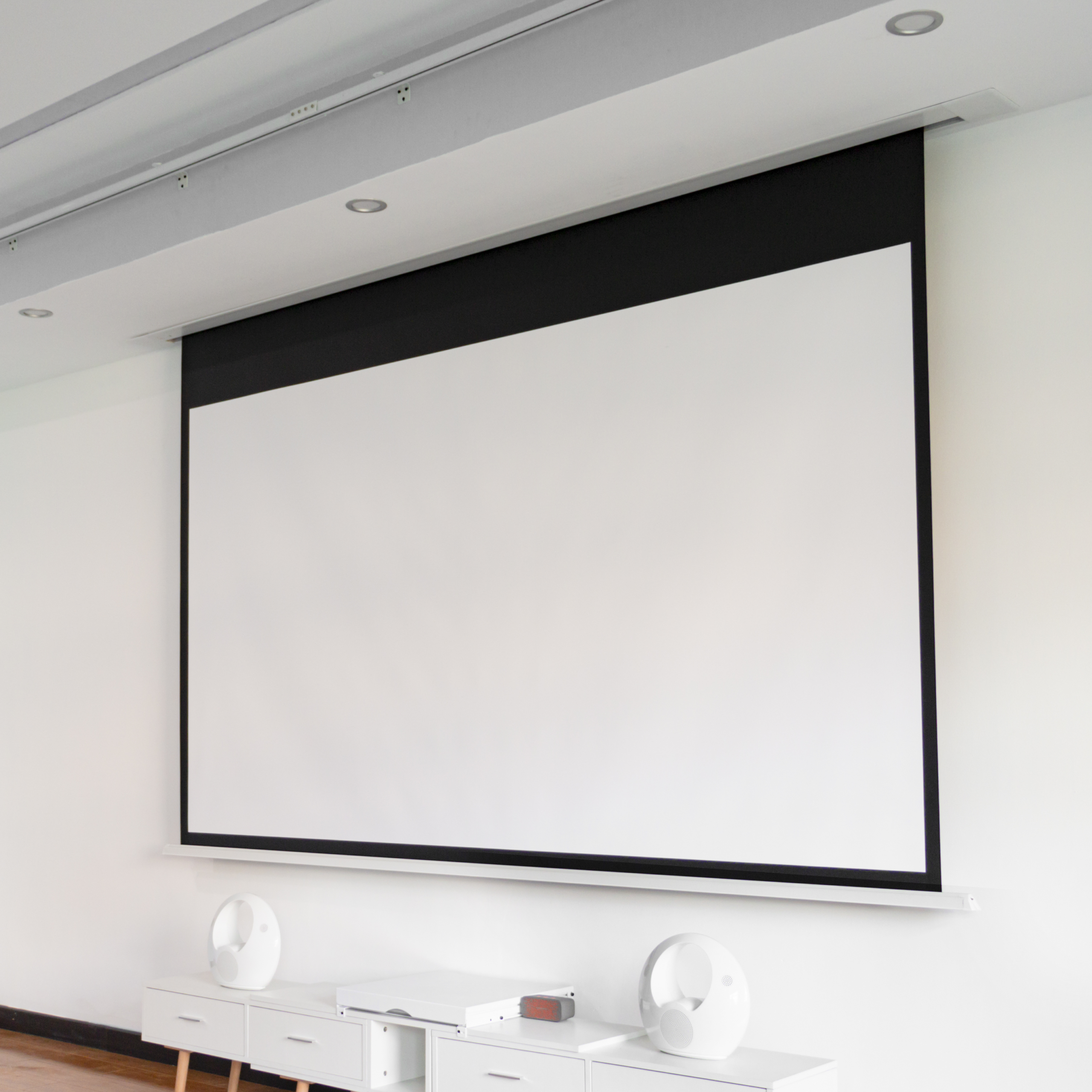 In-ceiling electric projection screen with hidden ceiling housing for home cinema installation