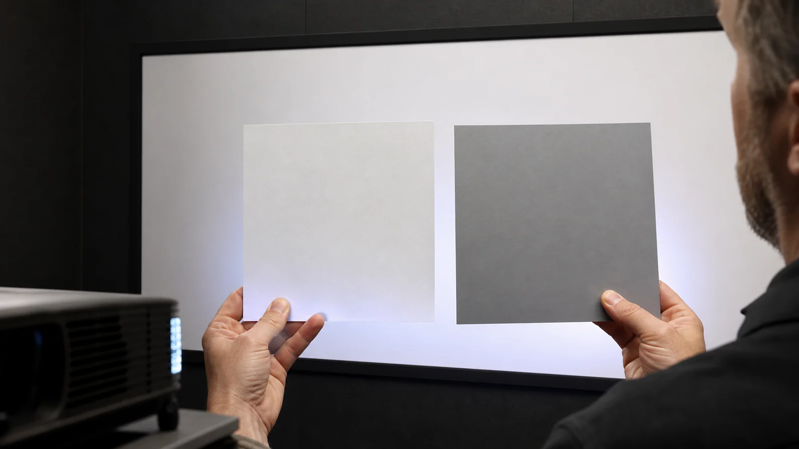 Close view of white and grey projection fabrics evaluated with dark scenes skin tones and text